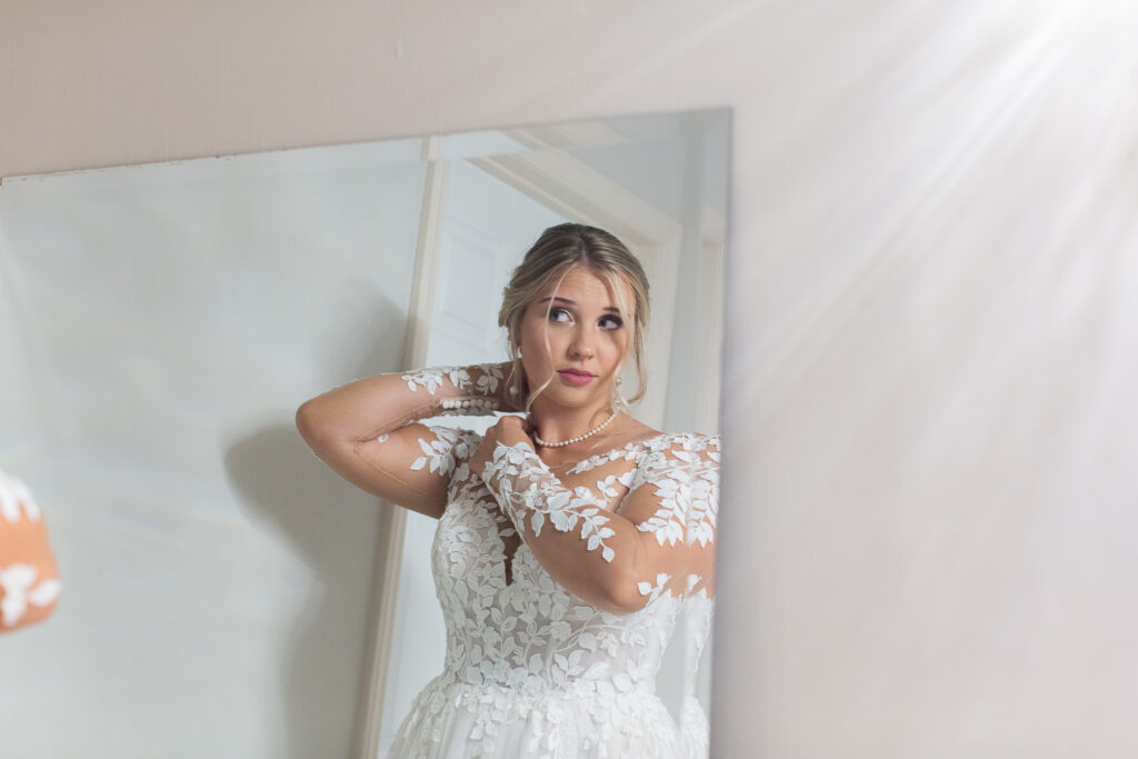 Bridal suite
Bride Getting Ready
Bride looking in the mirror fixing her hair