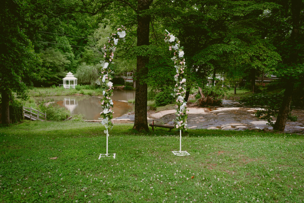 A wedding arch overlooking a pond at an outdoor wedding venue space near Greenville South Carolina