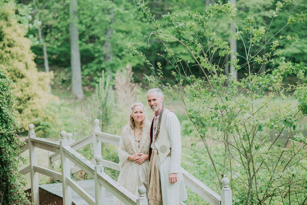 The bride and groom pose on a bridge at an outdoor wedding venue near Spartanburg South Carolina