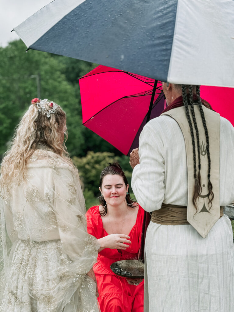 Bride and groom exchange vowels under umbrellas at an outdoor wedding venue near Greenville South Carolina