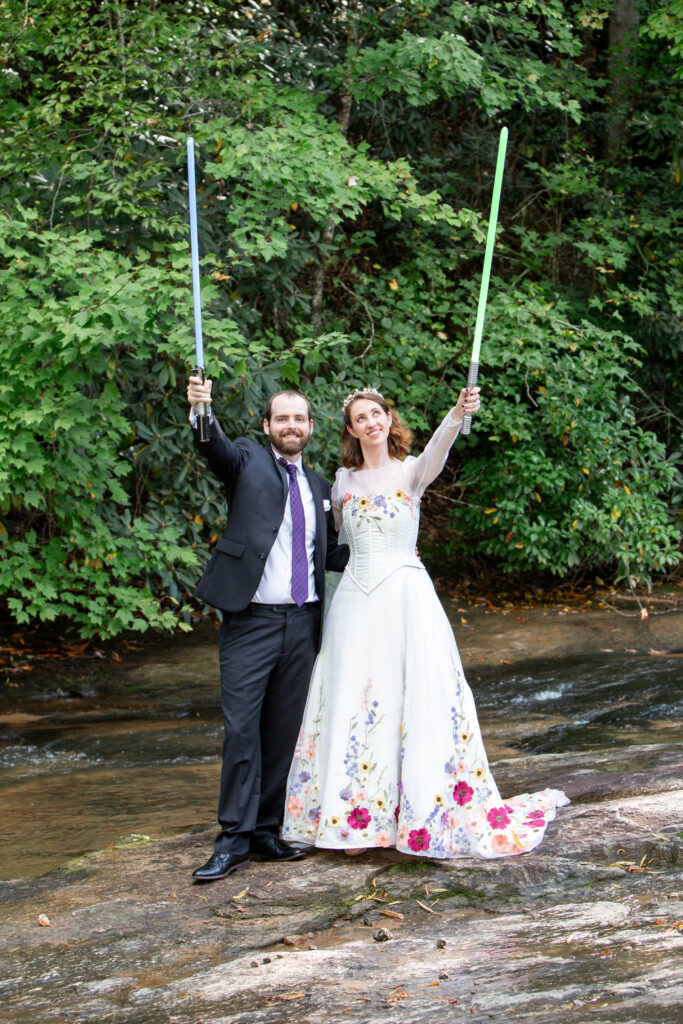 A bride and groom on the river at The Venue at Ballenger Bridge corset bodice trending wedding gown 2025