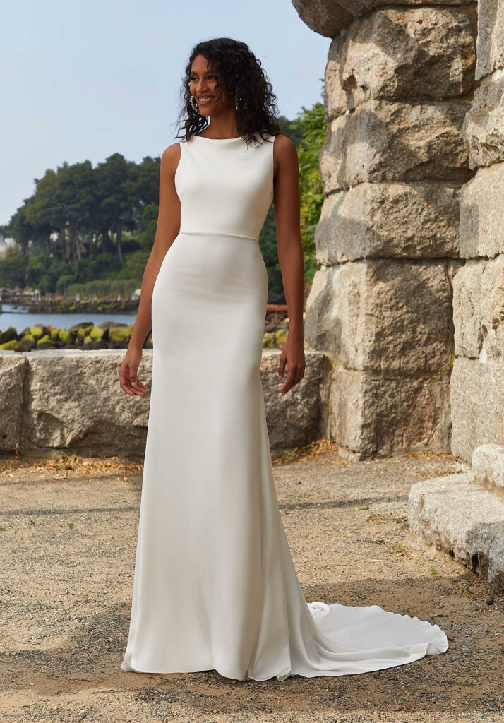 a bride wears a sleek, unembellished minimalist wedding gown trends for 2025