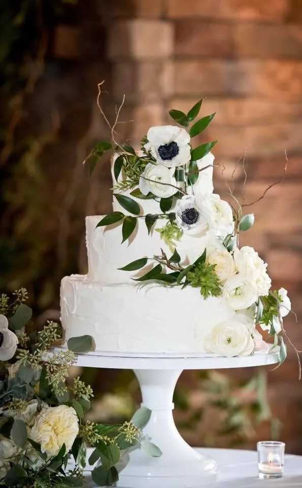 A wedding cake with florals by Inn Season in Greenville South Carolina