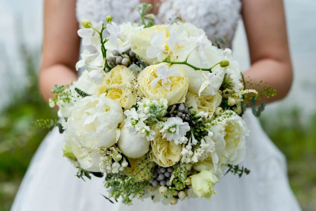 The bride holds a bouquet of yellow flowers crafted by Inn Season in Greenville South Carolina