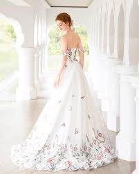 a wedding gown with pops of color through the skirt and bodice trending wedding gown 2025