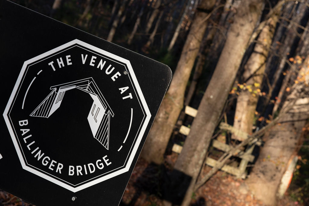  A sign for The Venue at Ballenger Bridge stands in front of the driveway Greenville wedding venue