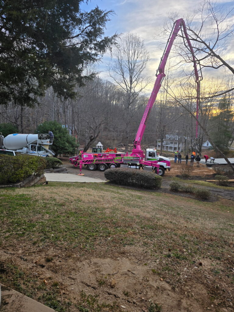 In this sunrise photo, a pumper truck pumps concrete onto the deck of the new covered bridge at an upstate South Carolina wedding venue
