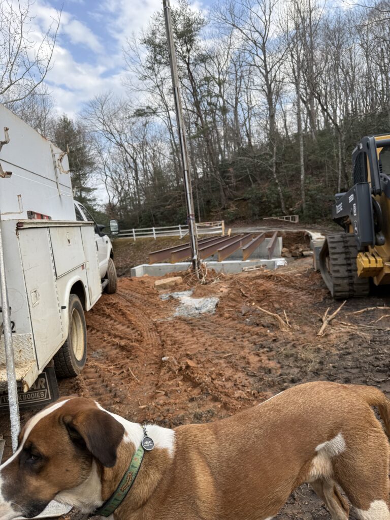 Six steel beams rest on their footings across the middle tiger river in Landrum South Carolina